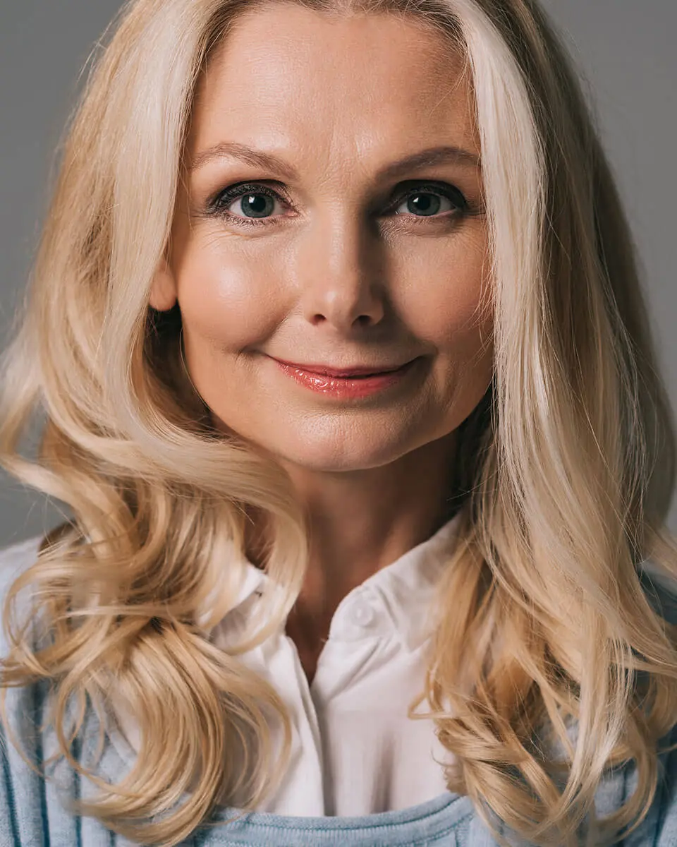 Mature woman with blonde hair smiling