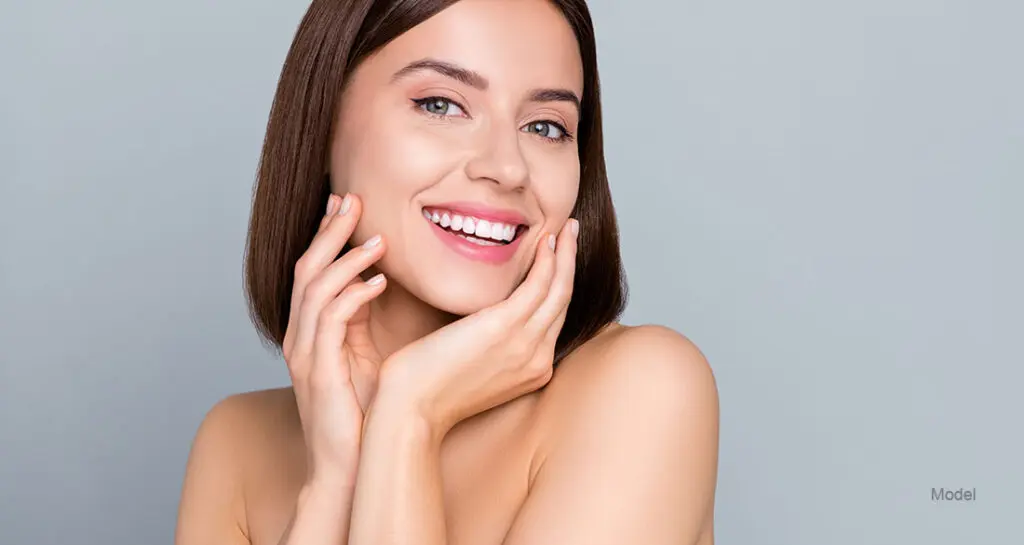 woman touching her face
